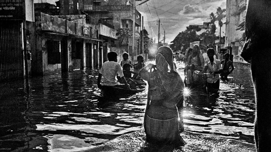 Shahidul Alam Bangladesh Wading down a street near Kamlapur railway station 1988
